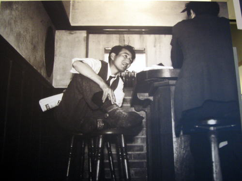 famous photo of dazai osamu drinking at bar lupin
