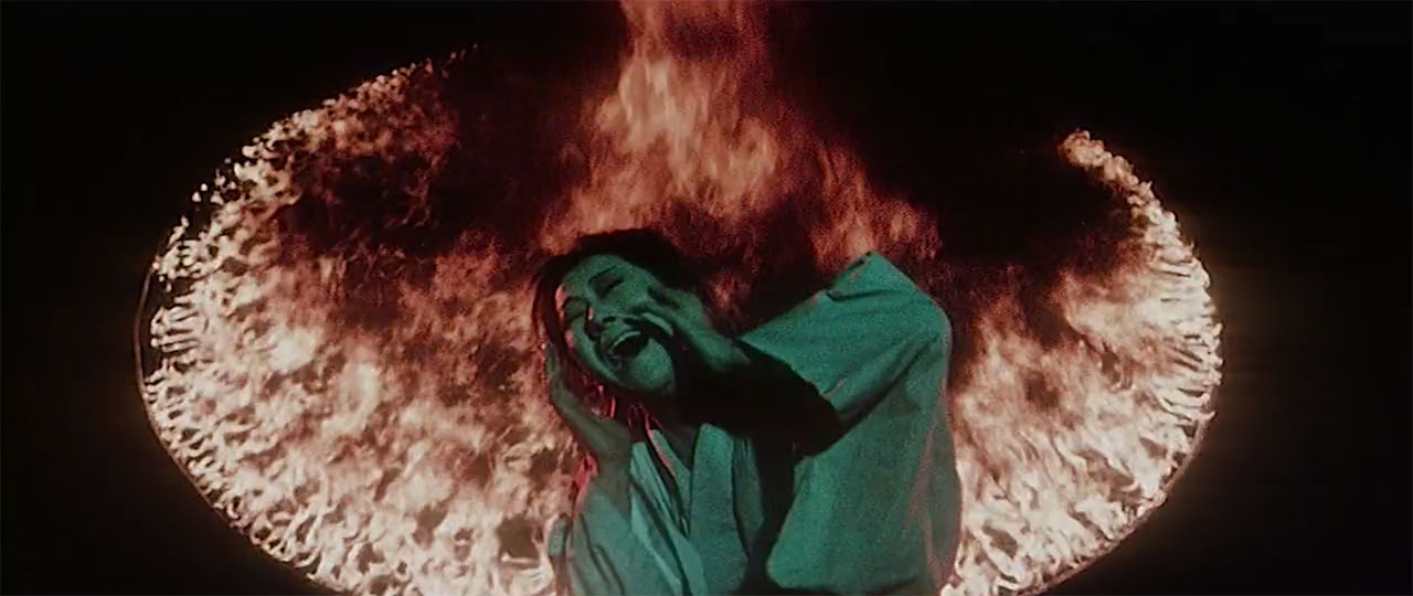 woman screaming in front of fire ring in jigoku